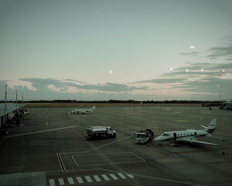 Private jet on tarmac at dusk under pastel sky