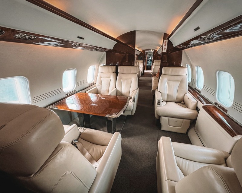 Luxury private jet cabin with cream leather seating